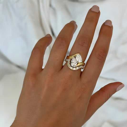 Hand wearing a gold and diamond ring on a plain 