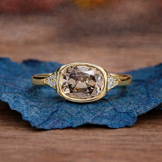 Gold ring with a large diamond on a blue leaf